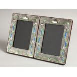 A PAIR OF SILVER AND ENAMEL PHOTOGRAPH FRAMES. 7.5ins x 5.5ins.