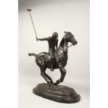 A LARGE BRONZE POLO PLAYER ON HORSEBACK on an oval marble base. 22ins long.