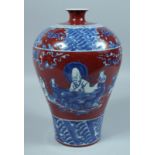 A CHINESE RED GROUND BLUE AND WHITE MEIPING VASE with figures. 12ins high.