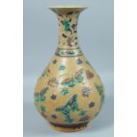 A LARGE CHINESE BROWN GLAZED VASE decorated with butterflies in relief. 14ins high.