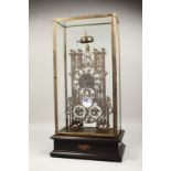 A LARGE CATHEDRAL BRASS AND ENAMEL MOON FACED SKELETON CLOCK striking on a single bell. 21ins high