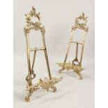 A LARGE PAIR OF BRASS EASELS. 21ins high.