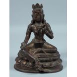 A CHINESE BRONZE BUDDHA on an oval base 7.5ins high.