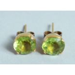 A PAIR OF 18CT GOLD PERIDOT EARRINGS.