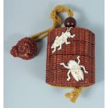 A JAPANESE CARVED WOOD AND BONE INRO on a rope with insects. 7cm long.
