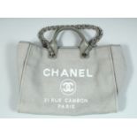 A GOOD CHANEL GREY FABRIC ADVERTISING BAG. 31 Rue Cambon, Paris, with chrome handles. 15ins wide,