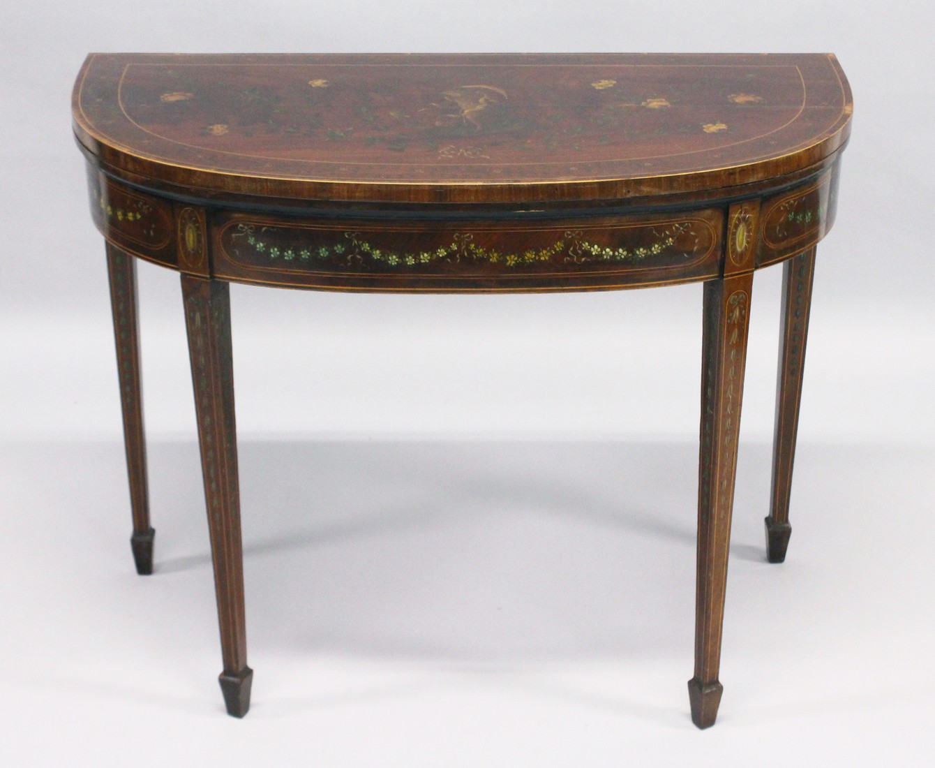 A GEORGIAN SHERATON REVIVAL MAHOGANY CARD TABLE painted with garlands and flowers with banded top