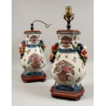 A PAIR OF PORCELAIN LAMPS with fruit handles. 17ins high.