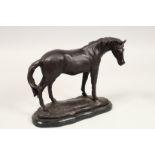 A BRONZE HORSE on a shaped marble base. 10ins long.