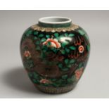 A CHINESE FAMILLE NOIR VASE painted with a dragon design. 6.5ins high.