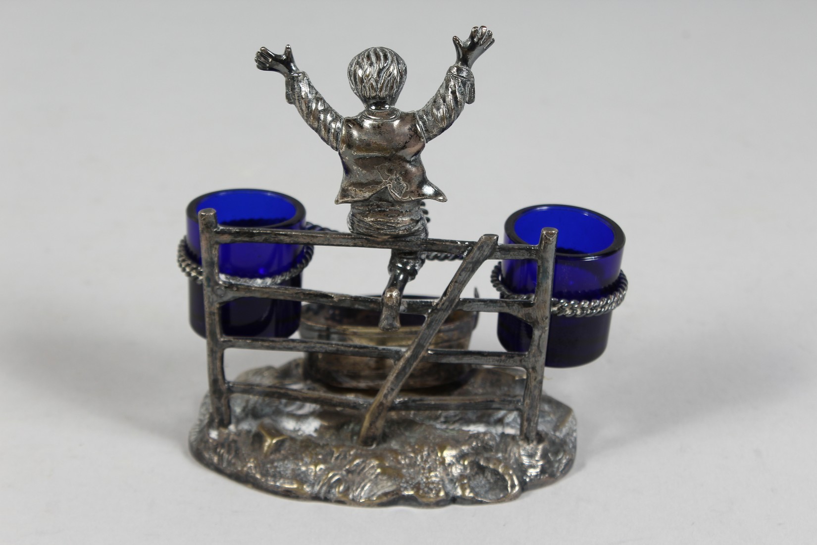 A VICTORIAN METAL DOUBLE SALT, a young boy jumping a style. - Image 3 of 7