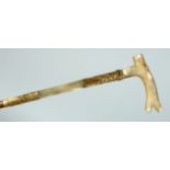 A GOOD EDWARDIAN ALLIGATOR WALKING STICK with gilt bands and mother of pearl handles. 36ins long.