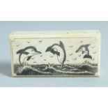 A BONE BOX with folding top with three dolphins 2.5ins long.