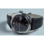 A ROLEX OYSTER PERPETUAL AIR - KING - DATE BLACK FACE WRISTWATCH with leather strap.