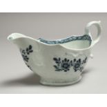 A JAMES PENNINGTON LIVERPOOL SAUCE BOAT well moulded and painted with blue under glaze flowers.