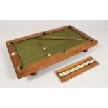 A RARE NUKU MINIATURE BILLIARD TABLE with slate base and green baize, in a fitted wooden case. 20ins