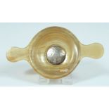 A SMALL TWO HANDLED HORN QUAICH with silver tablet, SCUAB. 2.5ins diameter.