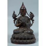 A CHINESE BRONZE BUDDHA on an oval base. 8ins high.