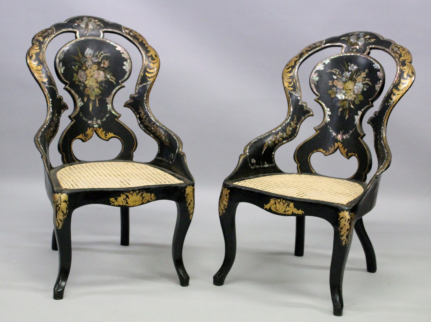 A GOOD PAIR OF VICTORIAN BLACK PAPIER MACHE CHAIRS painted with flowers and inlaid with mother of