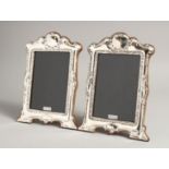 A PAIR OF SILVER SCROLLING PHOTOGRAPH FRAMES. 8ins x 6ins.