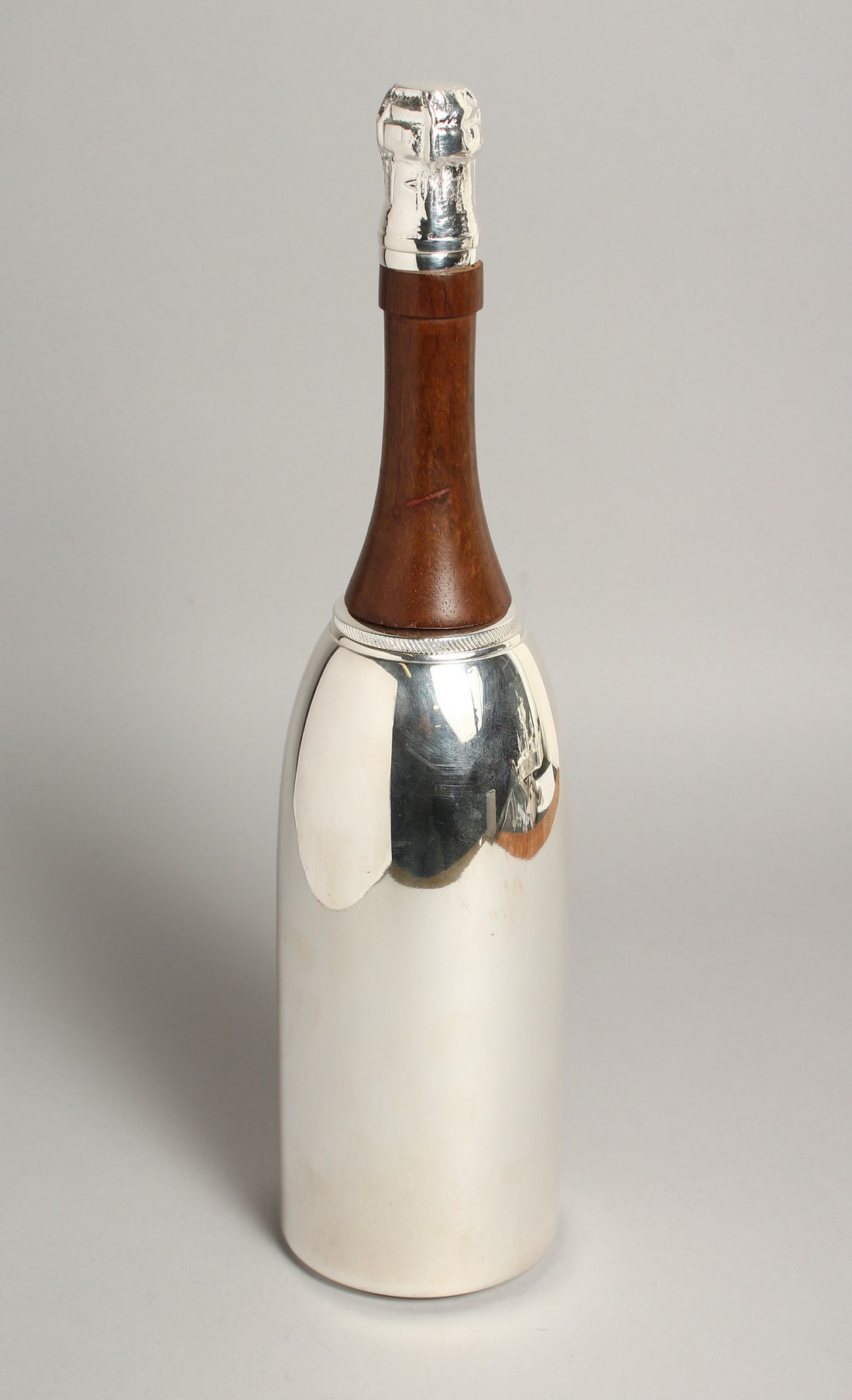 A PLATED CHAMPAGNE BOTTLE COCKTAIL SHAKER 15ins high.