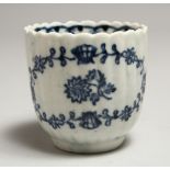A JOHN PENNINGTON REEDED COFFEE CUP painted with flowers in underglaze blue.