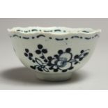 A JAMES PENNINGTON LIVERPOOL SERRATED RIM TEA BOWL painted with flowers in blue underglaze.