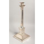 A PLATED CORINTHIAN COLUMN LAMP on a square base. 17ins high.