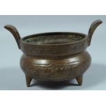 A CHINESE TWIN HANDLED CIRCULAR BRONZE CENSER. 5.5ins diameter.