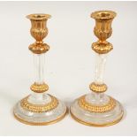 A GOOD PAIR OF ROCK CRYSTAL AND GILT METAL CANDLESTICKS. 7.5ins high.