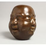 A LARGE CHINESE BRONZE FOUR FACED BUDDHA HEAD. 7.5ins high.