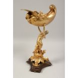 A GOOD GILT BRONZE SHELL held aloft by a classical female on a bronze base. 15ins high.