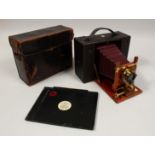 AN EARLY KODAK CAMERA, RED BELLOWS, in a leather case.