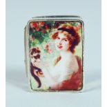 A SILVER AND ENAMEL PILL BOX with a girl and cat. 3cm long.
