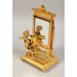 A GOOD GILT BRONZE CUPID with a mirror. 9ins high.