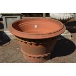 A large terracotta plant pot (lacking base).