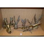 A quantity of cast brass ornaments of eagles and horses heads.