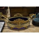 An ormolu jardiniere with blue glass liner.