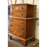 A small mahogany chest of drawers.