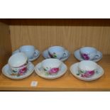 A set of six Continental porcelain cups and saucers and a spare cup.