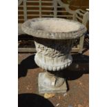 A large composite urn shaped garden planter.