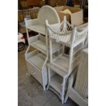 A wicker shelving unit and a pair of stools.