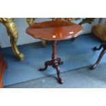 A mahogany tripod table.