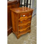 A small yew wood chest of drawers.