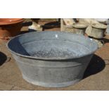 A large galvanised bath tub.