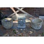 A pair of composite garden planters and a plant stand.