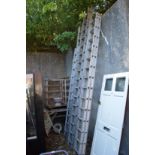 Various aluminium extending ladders.