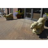 A good large pair of composite garden ornaments modelled as prowling lions on rocky outcrops.
