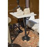 A marble topped garden table with cast iron supports.