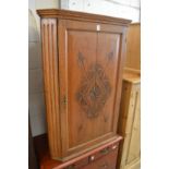 An oak hanging corner cupboard.